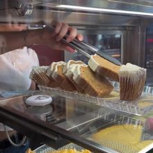 Cake slices and a tart in the pastry display