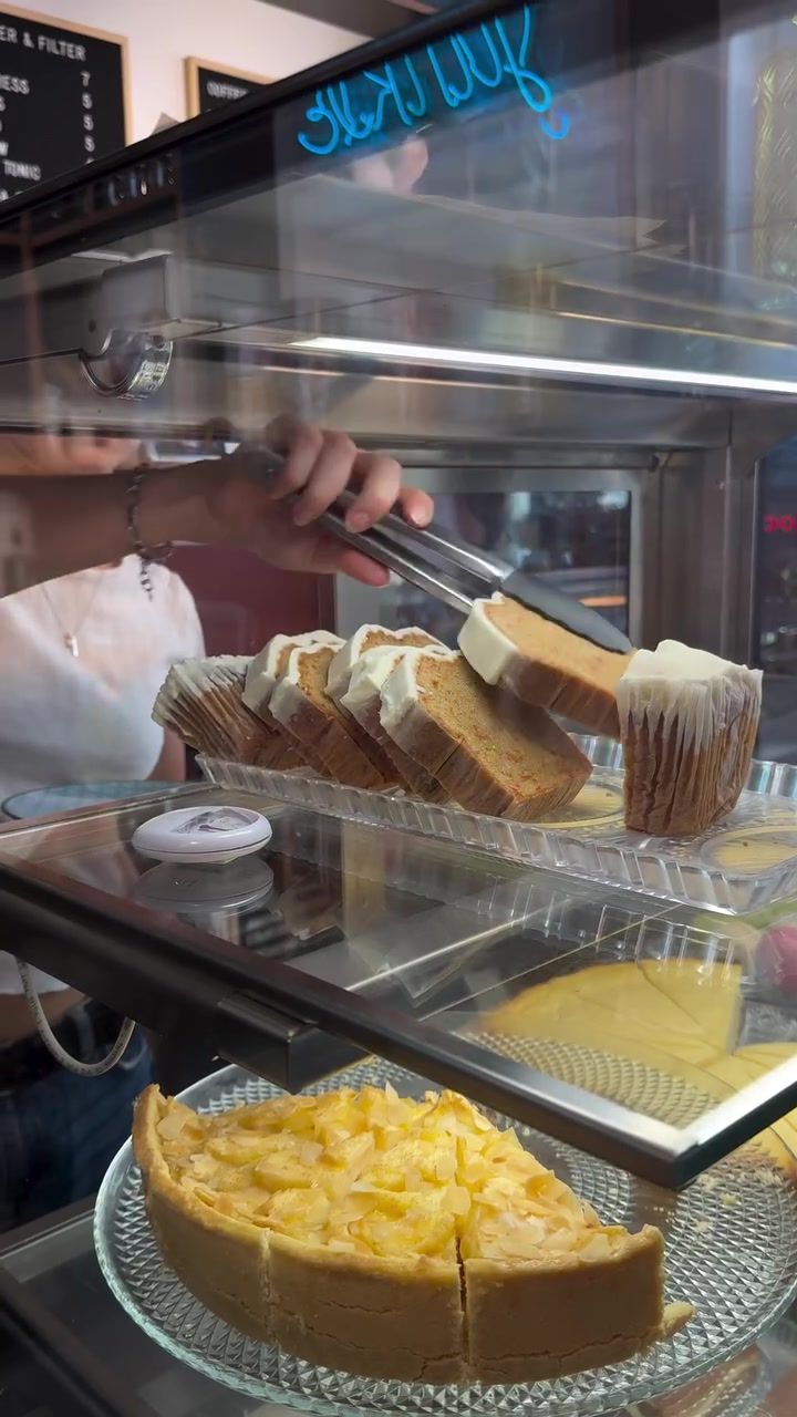 Sponge cake slices and a tart in the glass pastry case